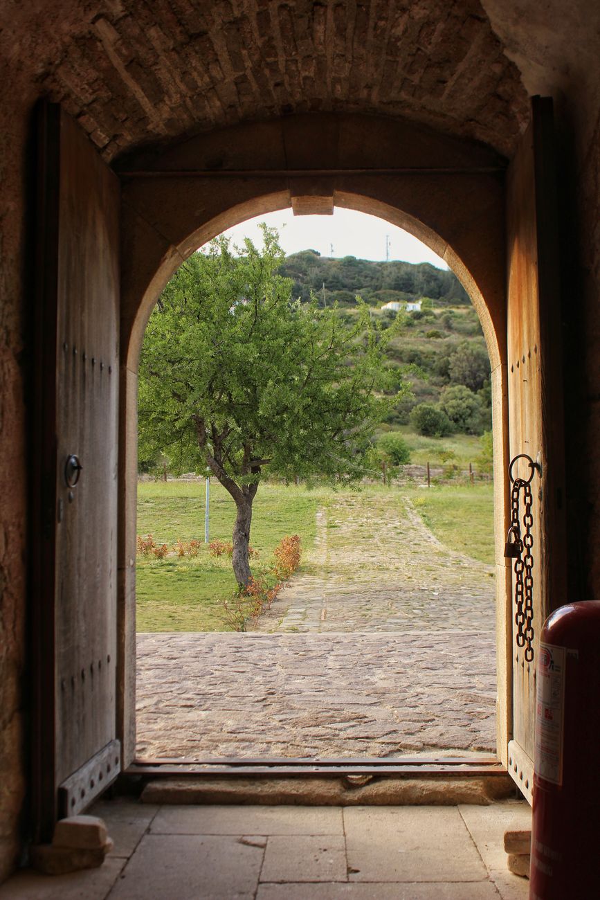 rustic archway opening to scenic greenery